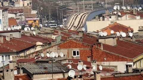 Satellite Dishes Adorning Red Roofs in Turkey: A Common Sight